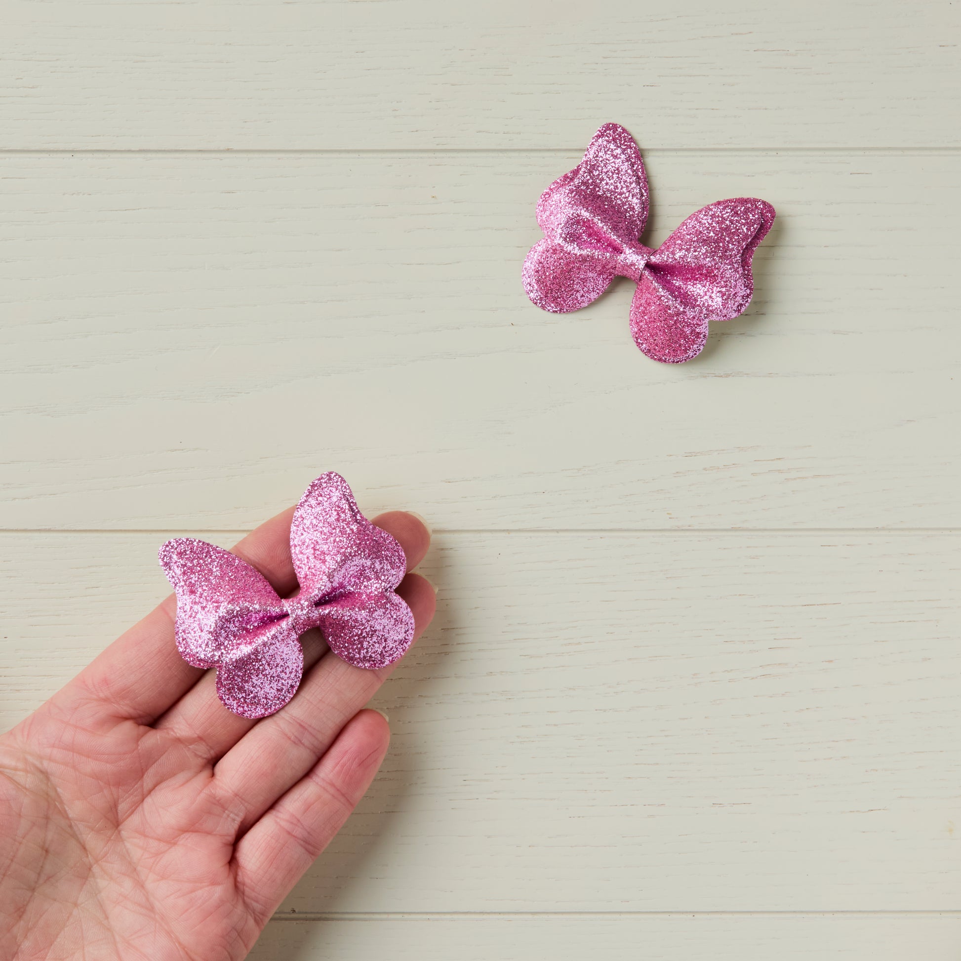 Pink butterfly pinch bow clips