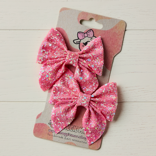A pair of hair bows on a display card
