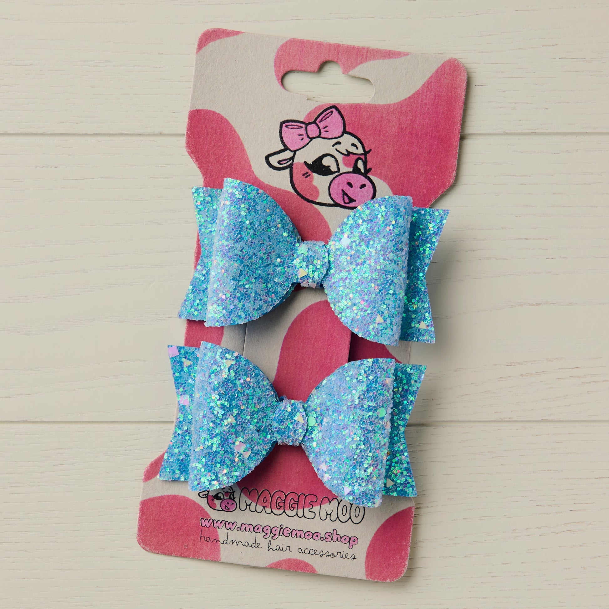 two frosty blue hair bows on a display card
