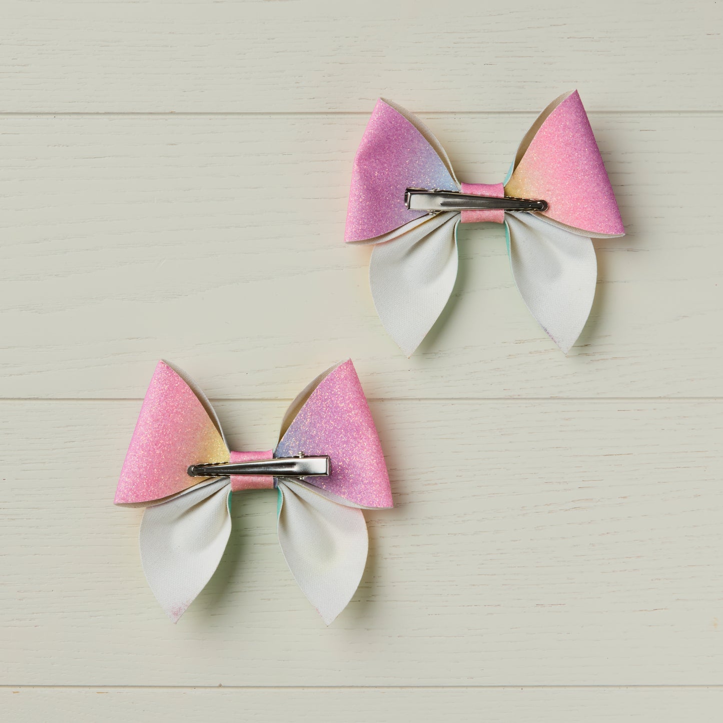 photo showing back of the bows with alligator clips facing opposite directions to illustrate left and right clip