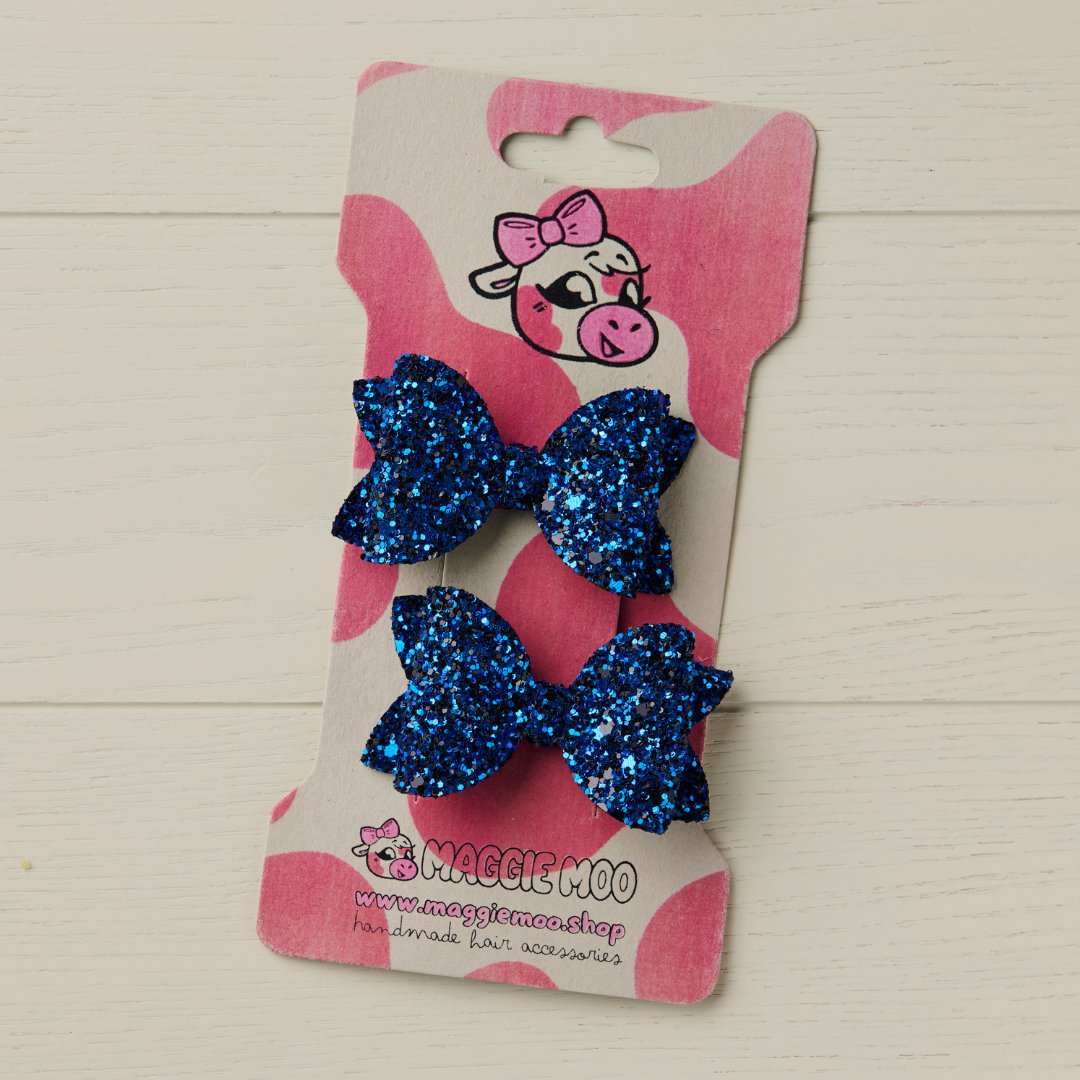 black mini glitter bows on a display card