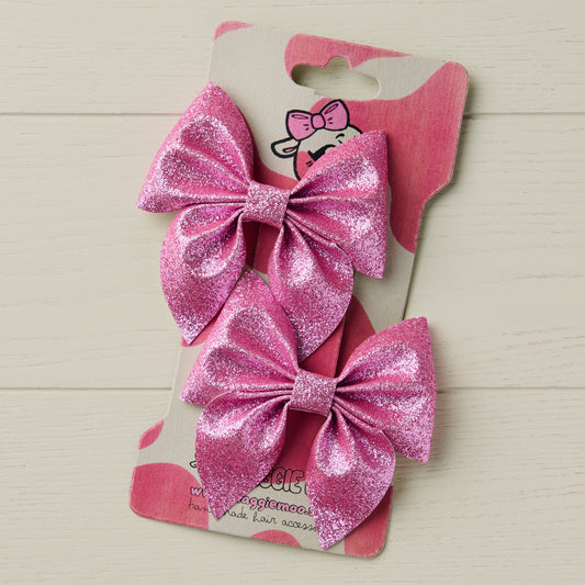 Pink glitter bows on a display card