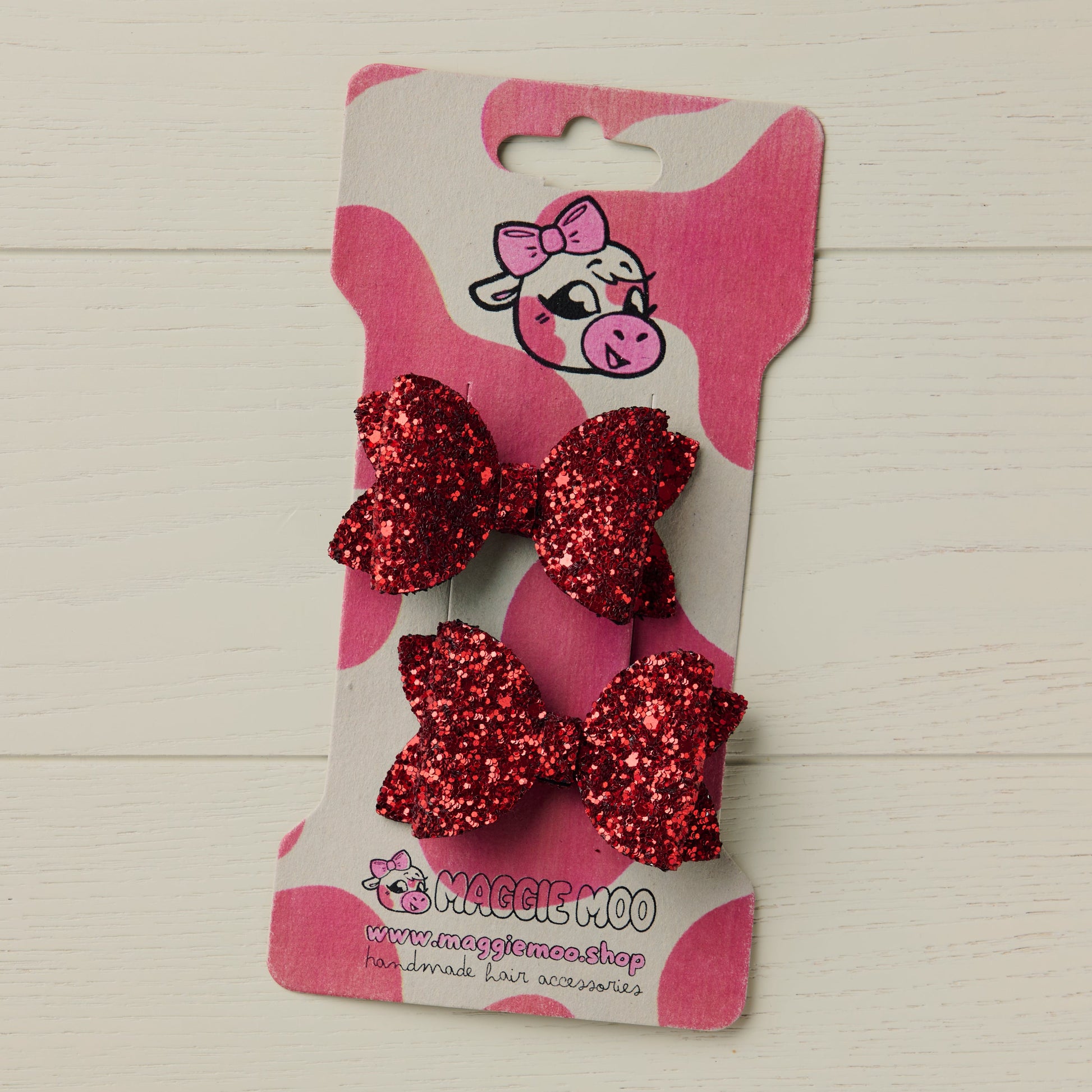 Red mini glitter hair bows on a display card