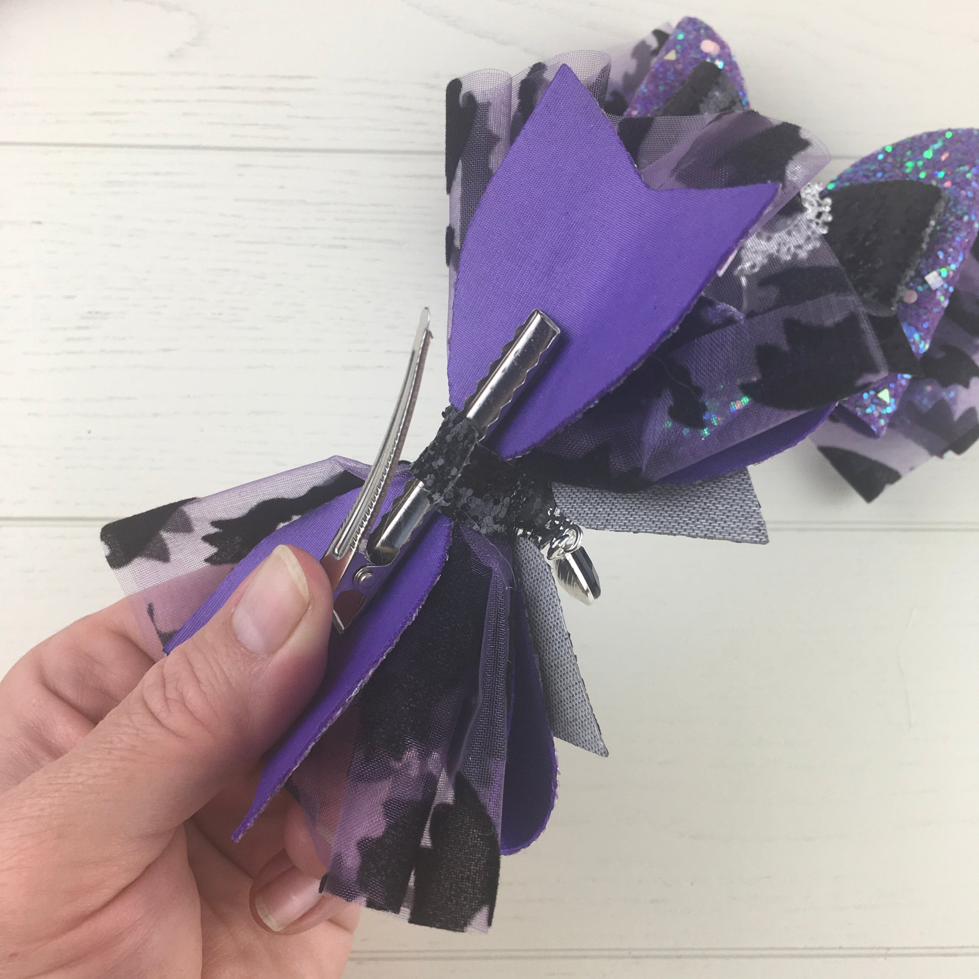 close up showing the alligator clip on the back of the hair bow