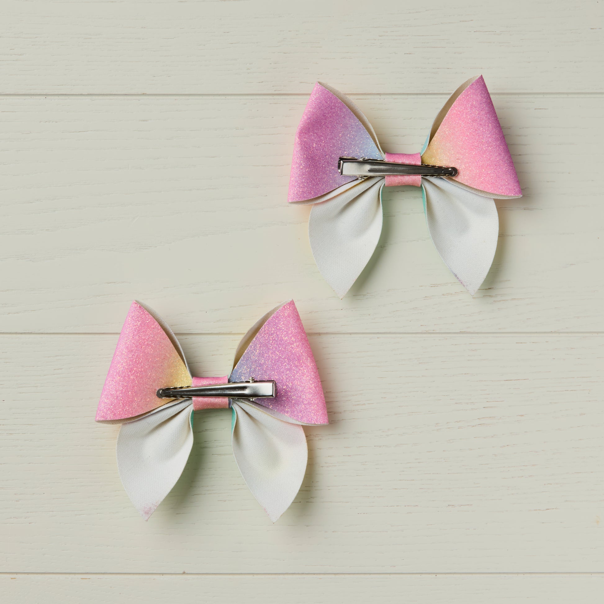 photo showing back of the bows with alligator clips facing opposite directions to illustrate left and right clip